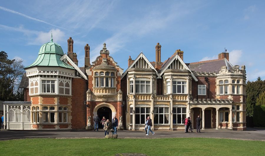 The Victorian mansion at Bletchley Park, England, behind a lawn