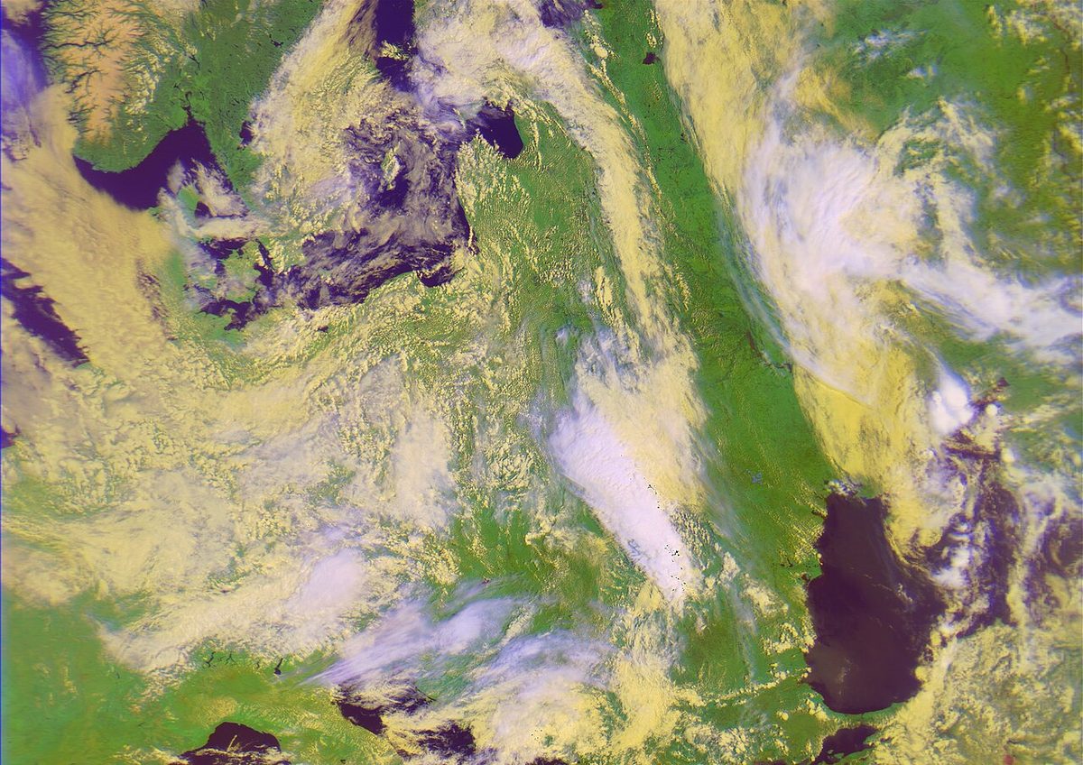 A false-colour satellite picture of swirling cloud over green land and dark seas