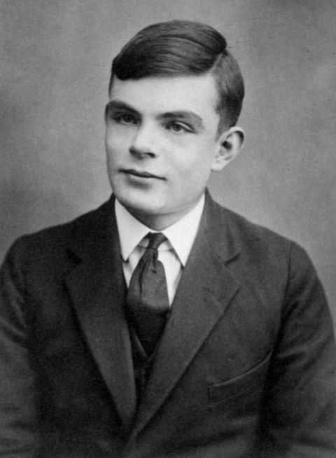 Black and white passport photograph of Alan Turing as a teenager, in a jacket and tie