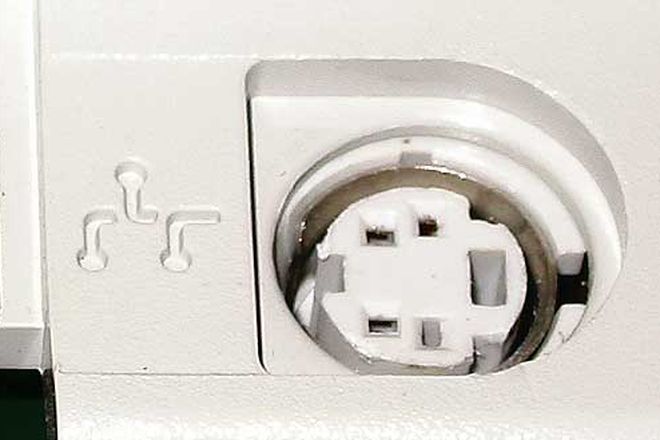 An ADB port on a Macintosh, marked with the ADB symbol