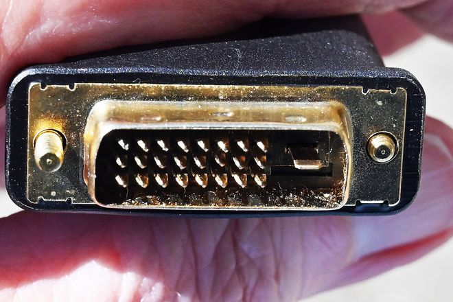 A DVI plug held in the hand
