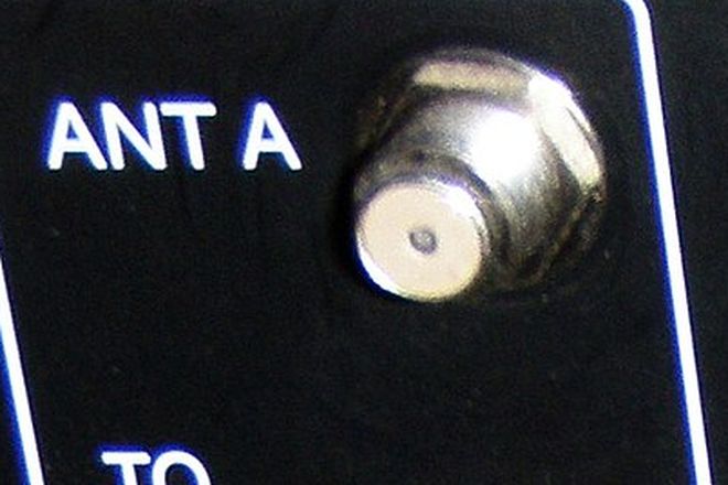 An F-type antenna socket on the back of a television, labelled ANT A