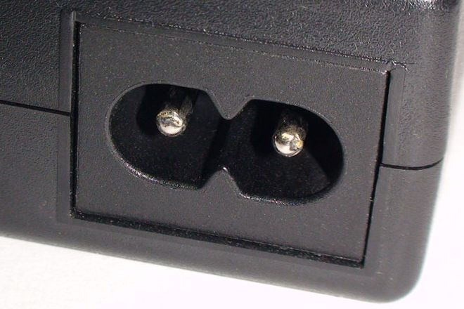 An IEC C8 figure-8 inlet on a power supply