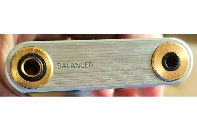 A 4.4 mm balanced headphone socket beside a 3.5 mm socket on a music player