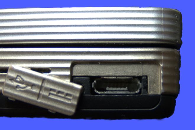 A USB Micro-AB port on a phone, with its rubber cover open