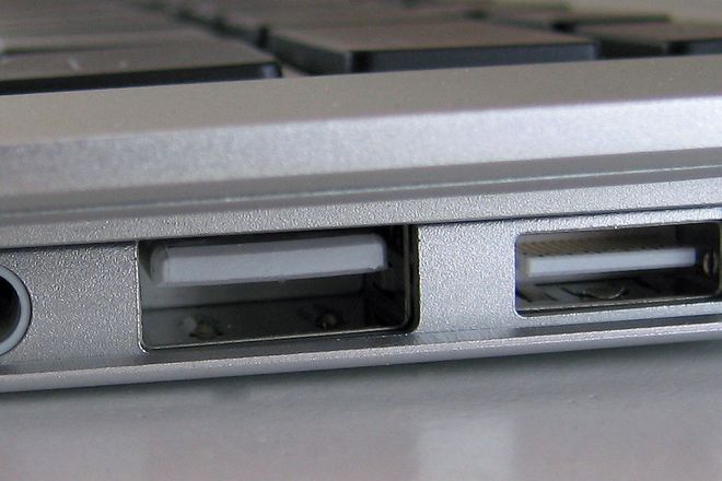 The fold-down port door of the original MacBook Air, with its Micro-DVI port