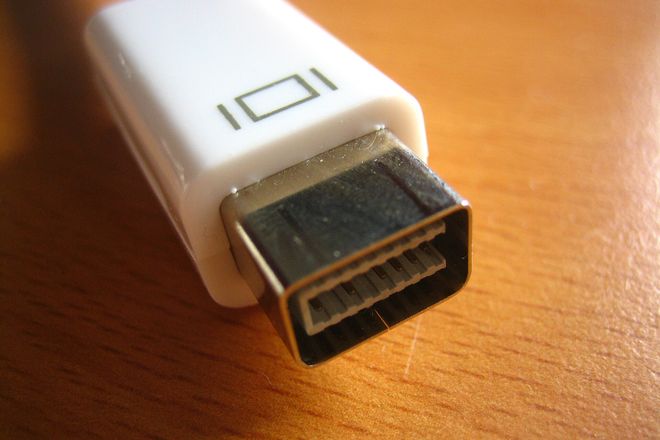 A Mini-DVI plug on an Apple adapter