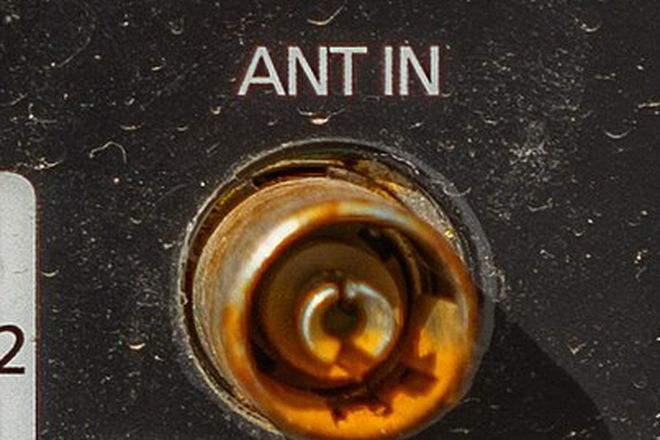 The antenna input socket on the back of a television, labelled ANT IN
