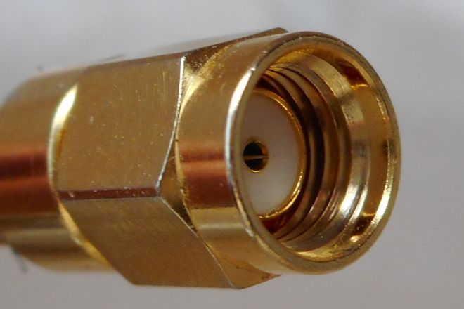 An RP-SMA plug on a cable: the same hex nut as SMA, but with a hole in the centre instead of a pin