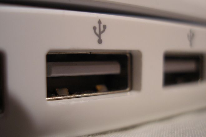 Two USB-A ports on a computer, each with a plastic tongue in the upper half