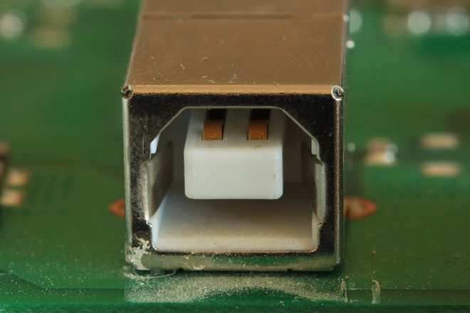 A USB-B port on a modem, showing the central block with its contacts