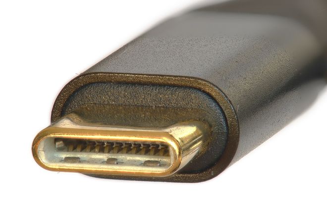 A USB-C plug seen end-on: a small oval with contacts along both inner faces
