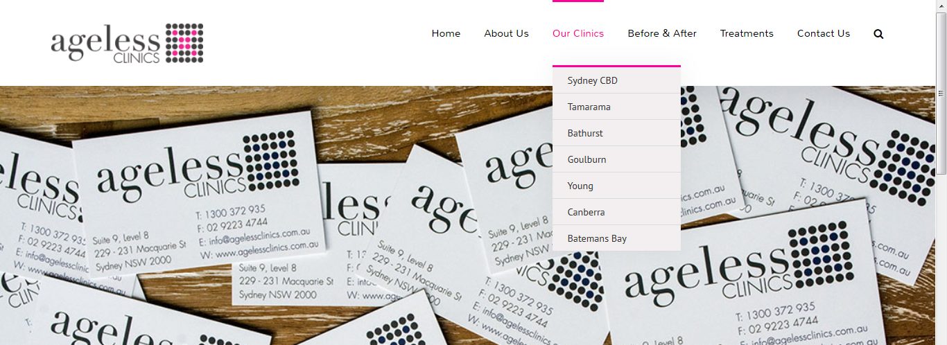 Archived Ageless Clinics website header, showing the pink-and-grey logo, the main navigation with Our Clinics expanded to a list of seven NSW and ACT clinic locations, and a hero image of clinic business cards on a wooden surface.