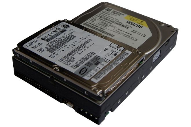 A 3.5-inch desktop hard drive beside a 2.5-inch laptop drive