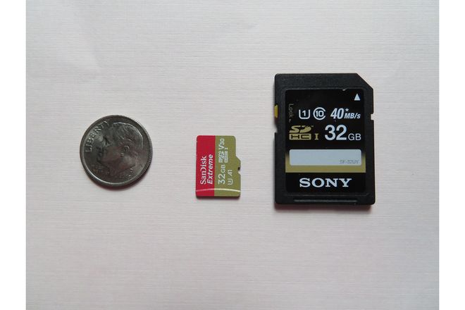 An SD card and a microSD card beside a coin for scale