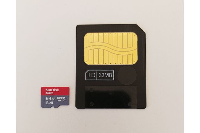 A 32 MB SmartMedia card beside a microSD card for scale