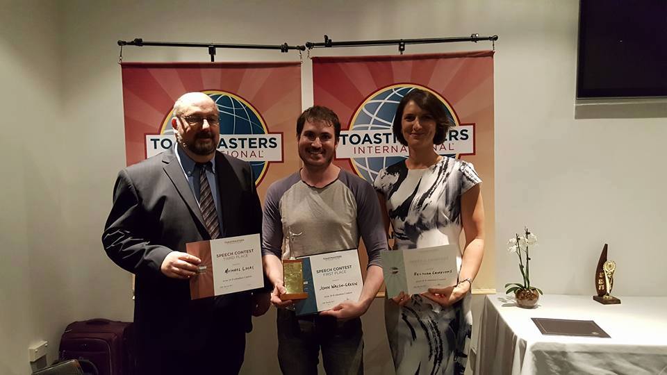 John Walsh-Green accepting First Place at the Toastmasters Area Evaluation Contest