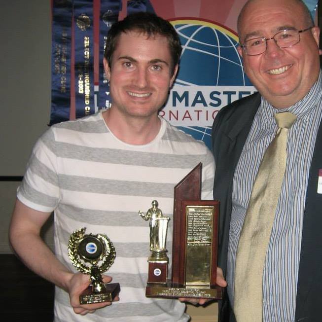 John Walsh-Green accepting a First Place award at a Toastmasters club contest